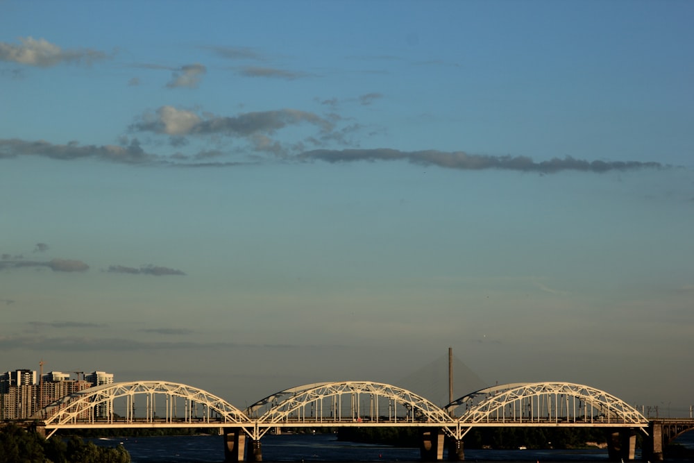 gray metal bridge under cloudy sky during daytime