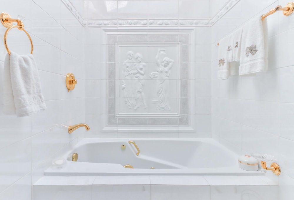 white ceramic bathtub with water