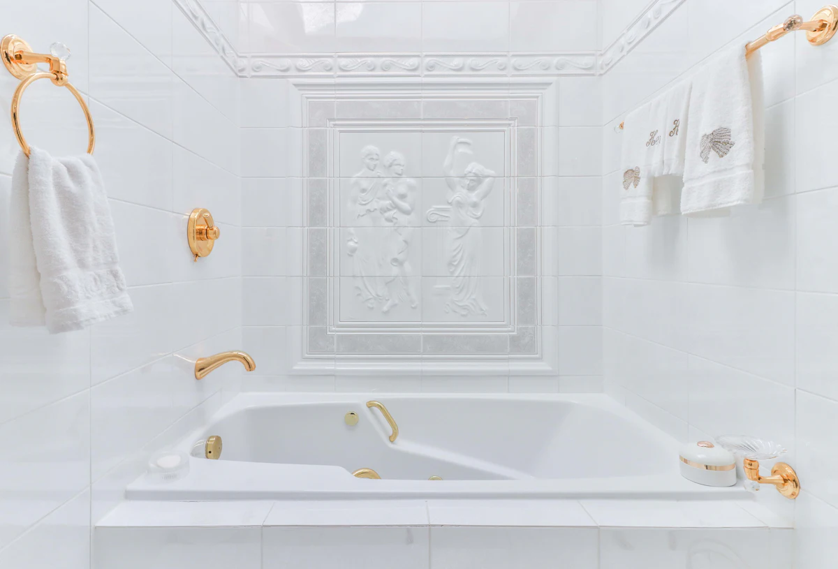 Calm bathroom with a white freestanding tub and tiled walls