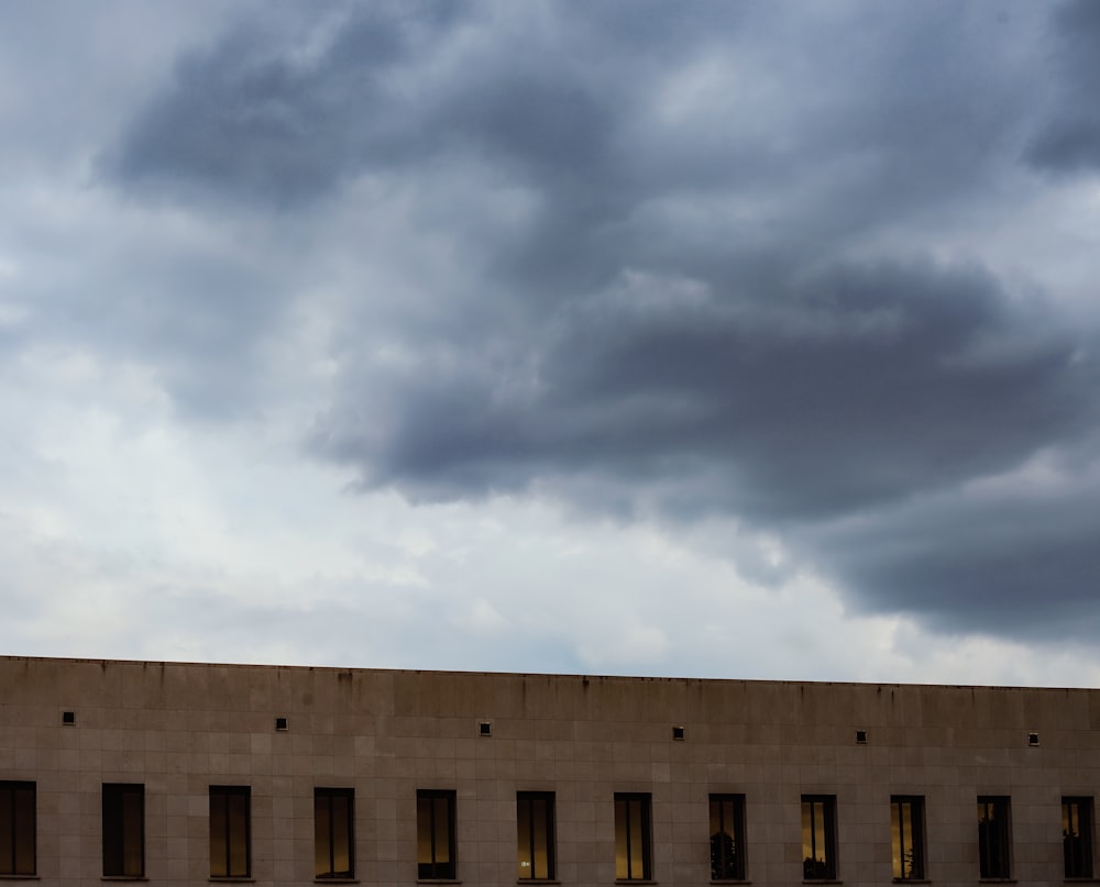 gray concrete building under cloudy sky during daytime