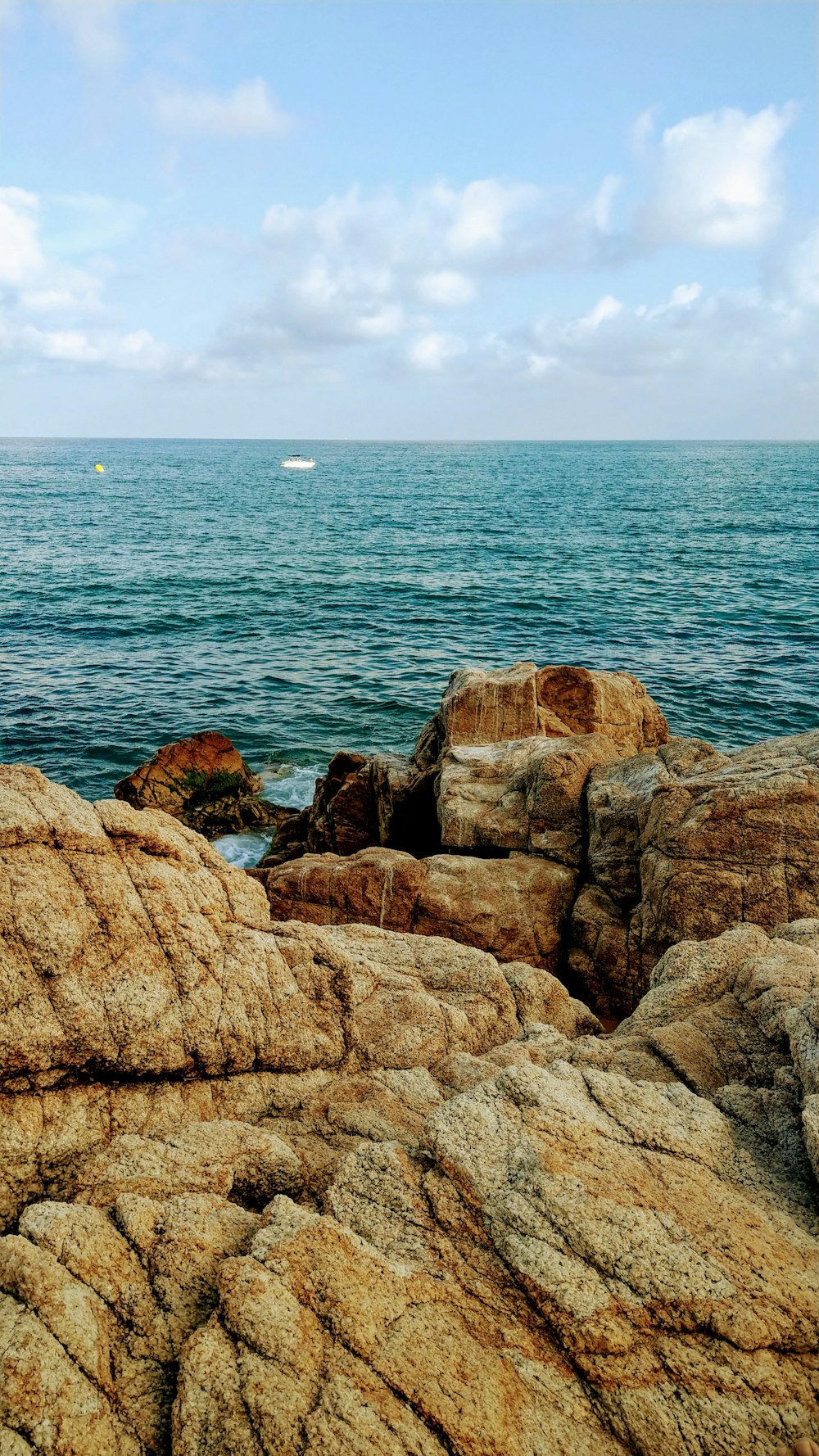 brown rock formation near body of water during daytime