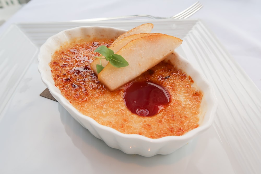 a white bowl filled with food on top of a table