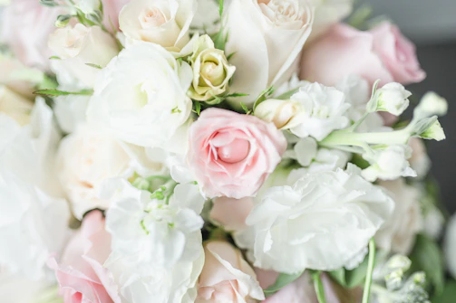 Close-up of a delicate bridal bouquet with soft pink roses and eucalyptus leaves.