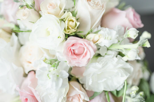 Close-up of a luxurious bouquet with soft pastel roses and delicate greenery.