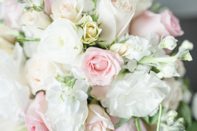 Close-up of a luxurious bouquet with delicate roses and greenery, highlighting texture and color.