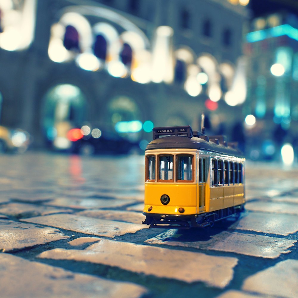 yellow and black train on the street during daytime