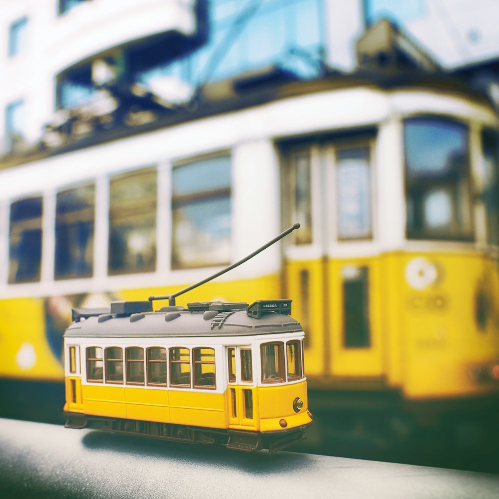 yellow and white train on rail during daytime