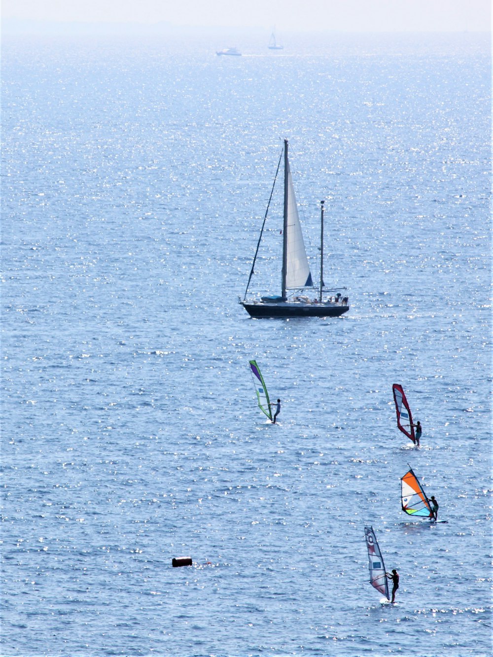 white sail boat on sea during daytime