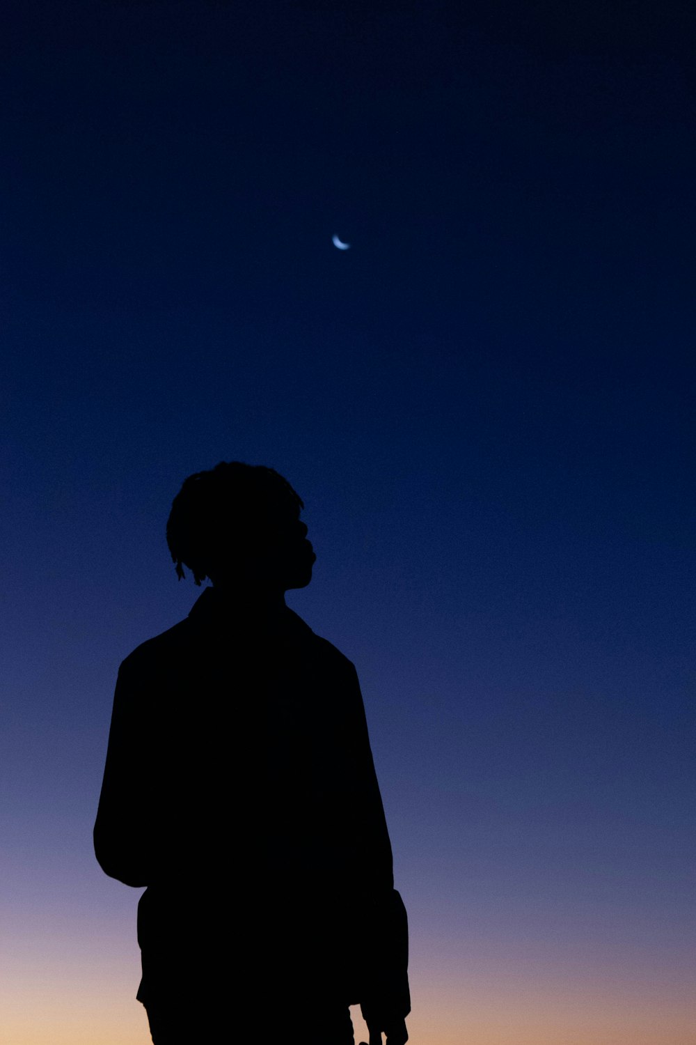 silhouette of man under full moon
