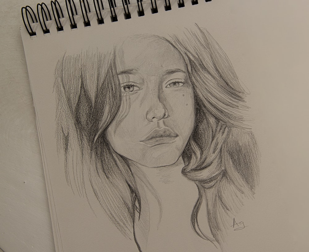 womans face sketch on white paper