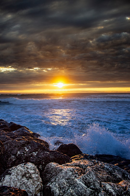 ocean waves crashing on rocks during sunset in Mimizan Plage France