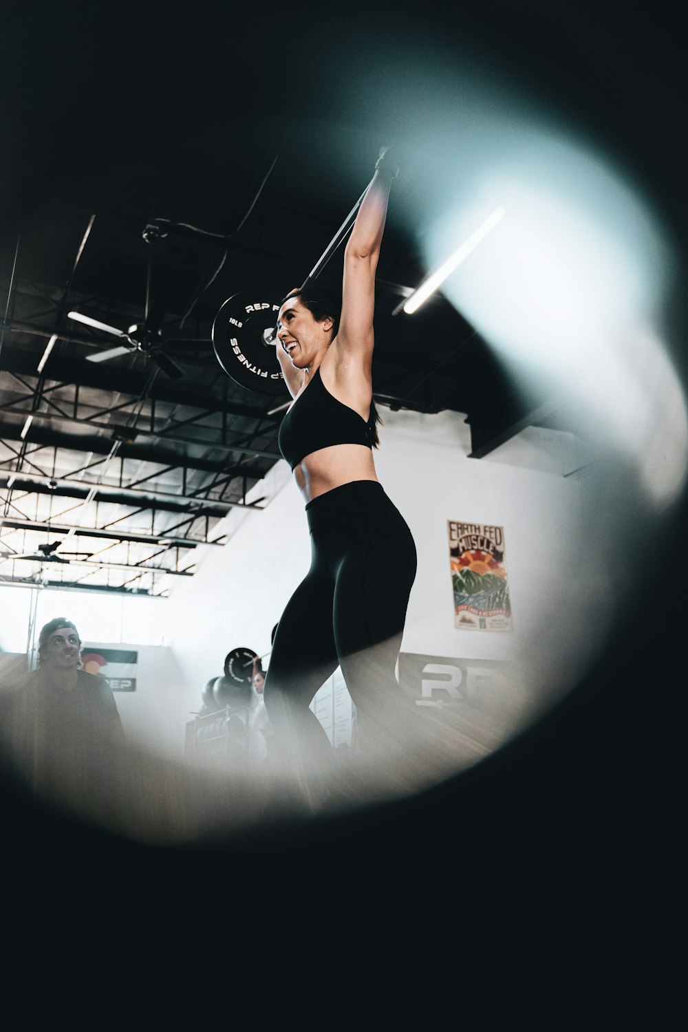 woman in black sports bra and black leggings doing yoga