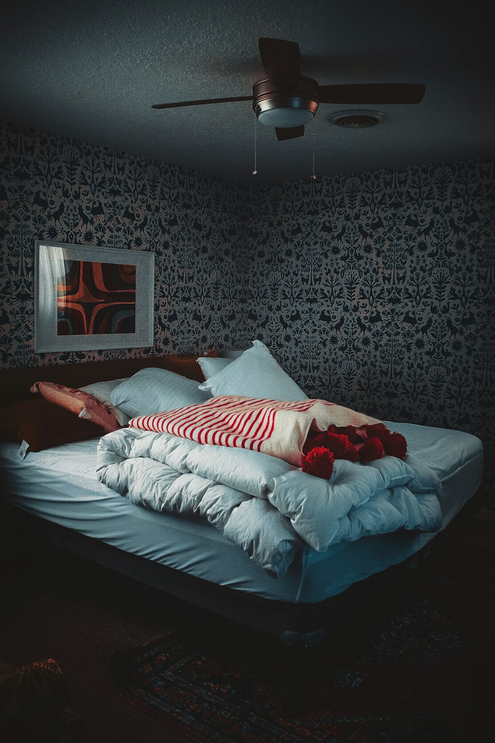 person lying on bed covered with blanket