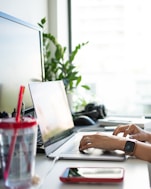 person using macbook pro on table