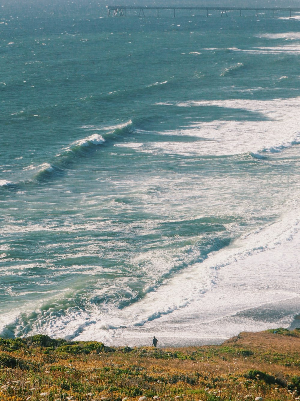 ocean waves crashing on shore during daytime