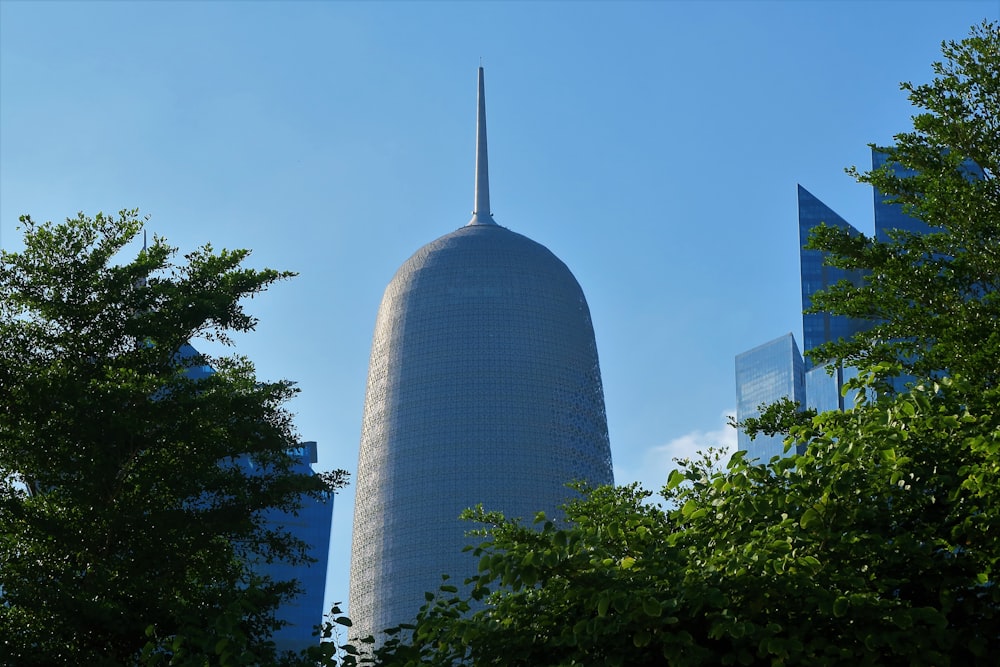 gray concrete building near green trees during daytime