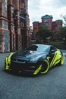 black and yellow lamborghini aventador parked near brown concrete building during daytime