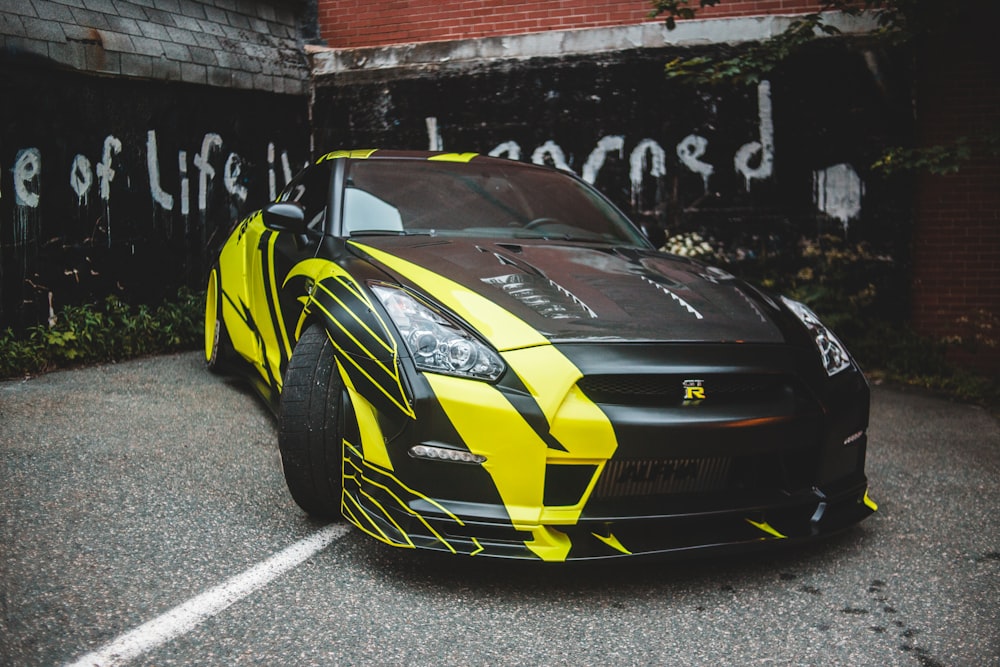 black and yellow lamborghini aventador parked on gray asphalt road during daytime