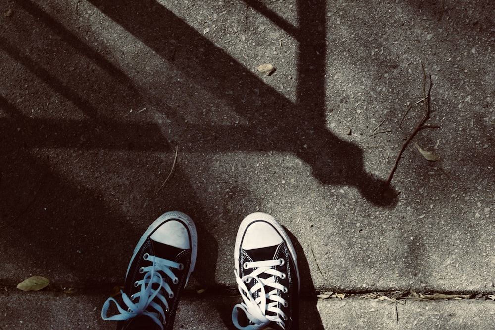 person wearing blue and white converse all star high top sneakers