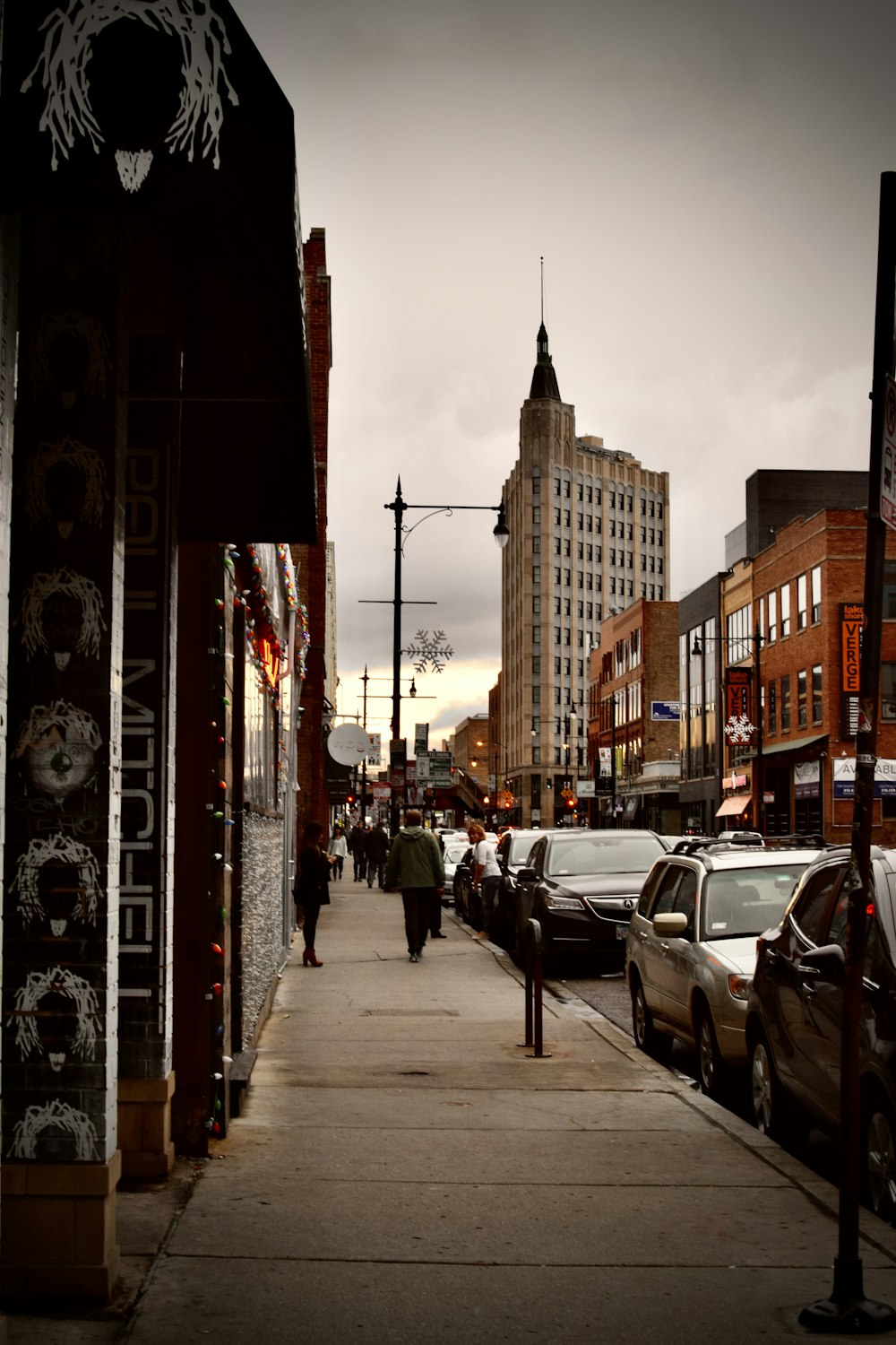 cars parked on sidewalk near buildings during daytime