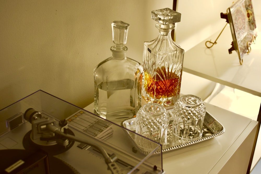 clear glass bottles on white metal rack