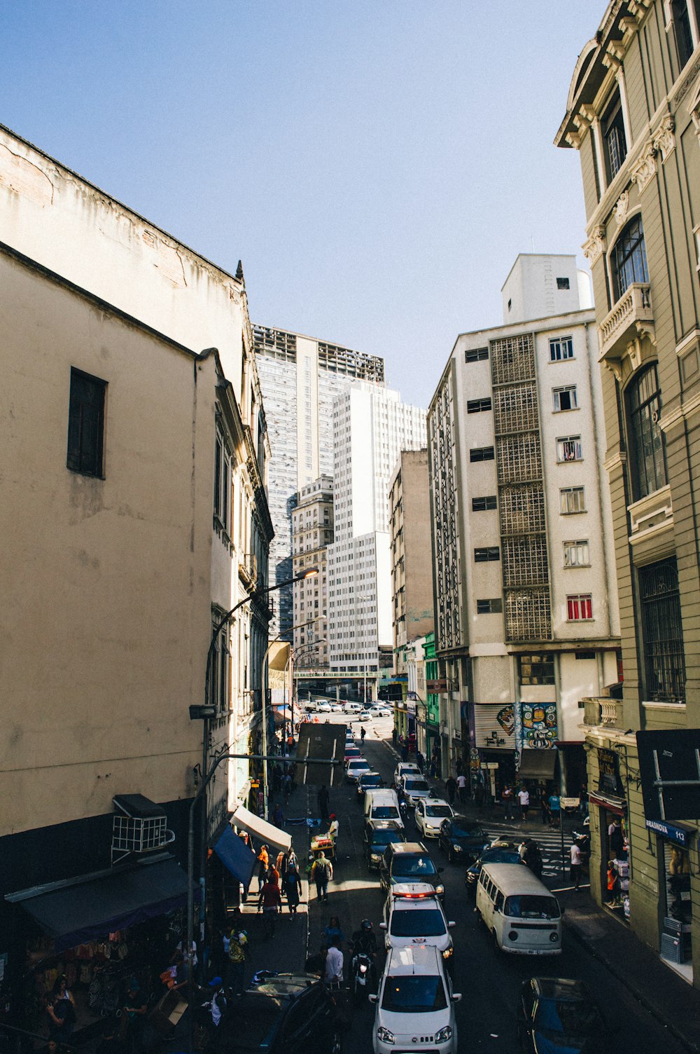 cars parked on side of the road near buildings during daytime