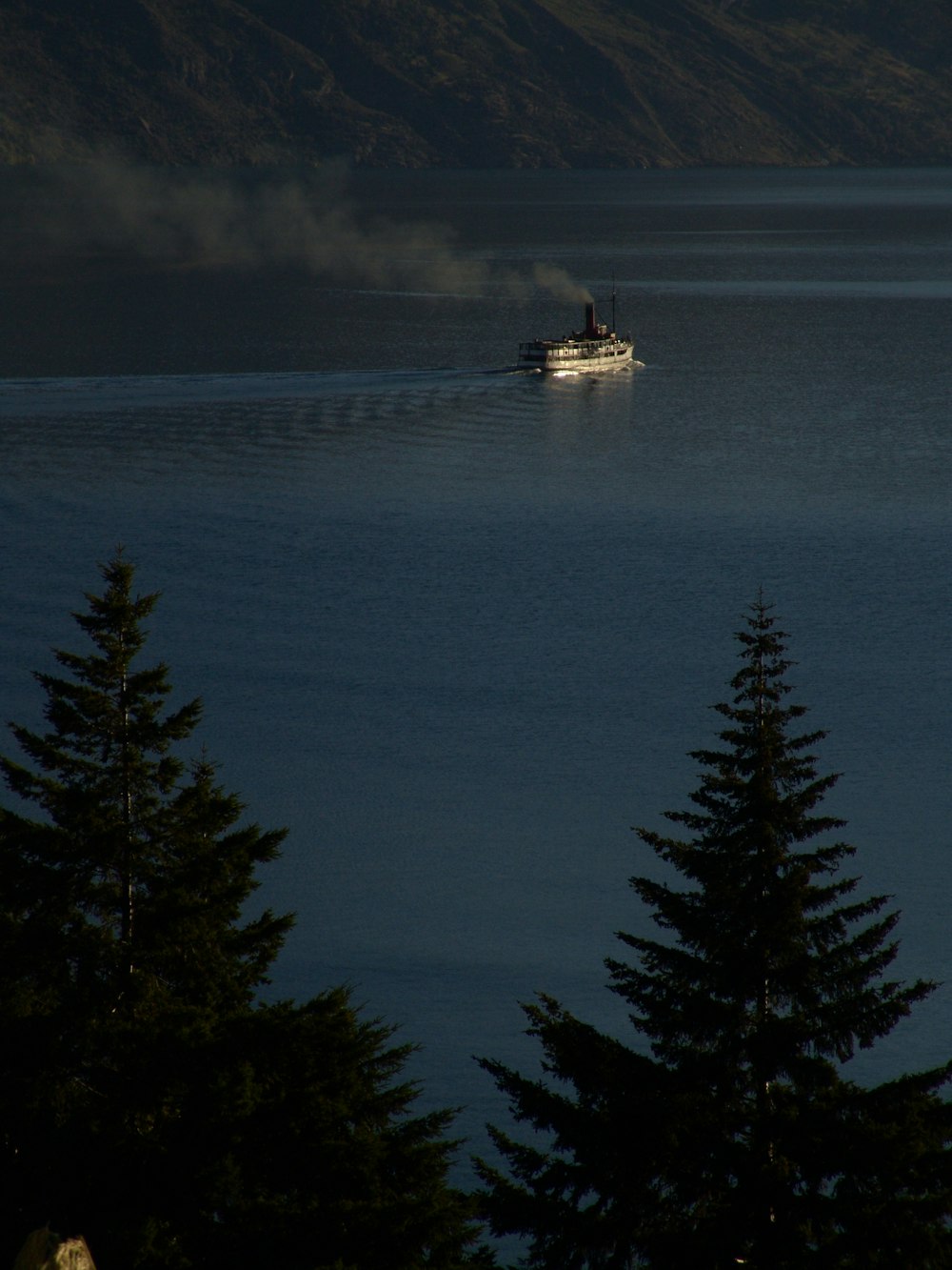 white boat on body of water during night time