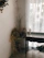 A cozy living room corner featuring a rustic reclaimed wood table adorned with a bouquet of dried wildflowers.