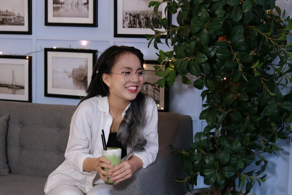 woman in gray cardigan sitting on gray couch