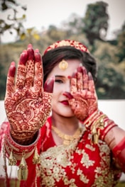 woman in red and gold floral hijab makeup by artist in kochi ready for the party