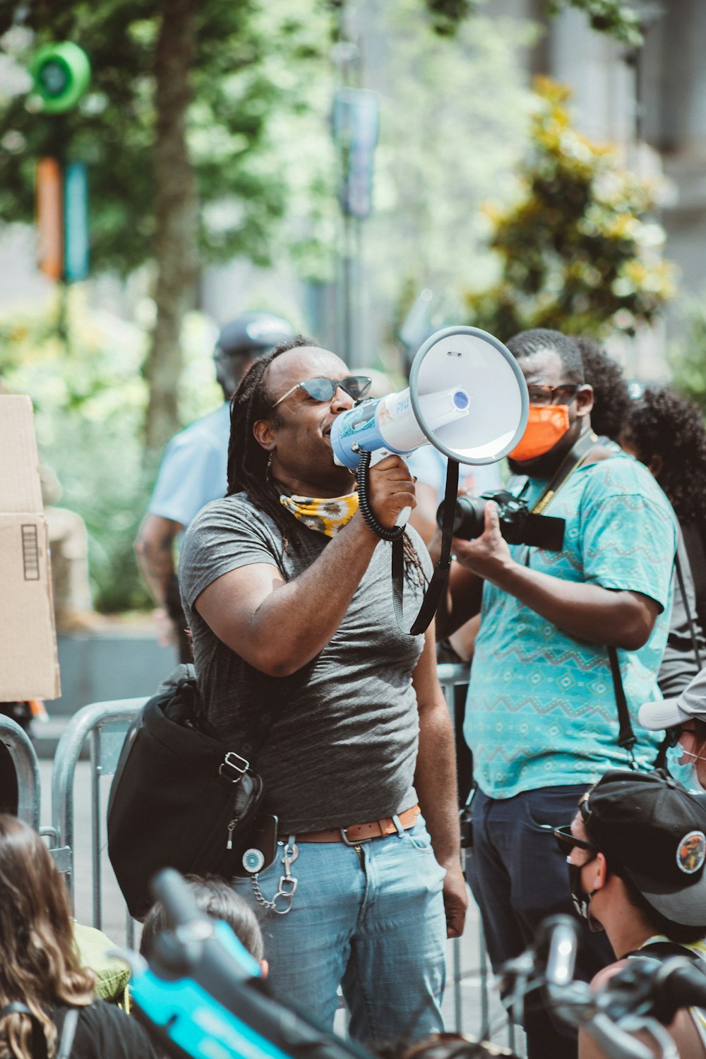 man in black t-shirt holding black and gray camera