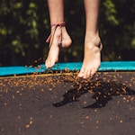 person wearing red and black flip flops