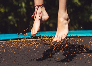 person wearing red and black flip flops