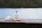orange and white plastic bottle on brown wooden table