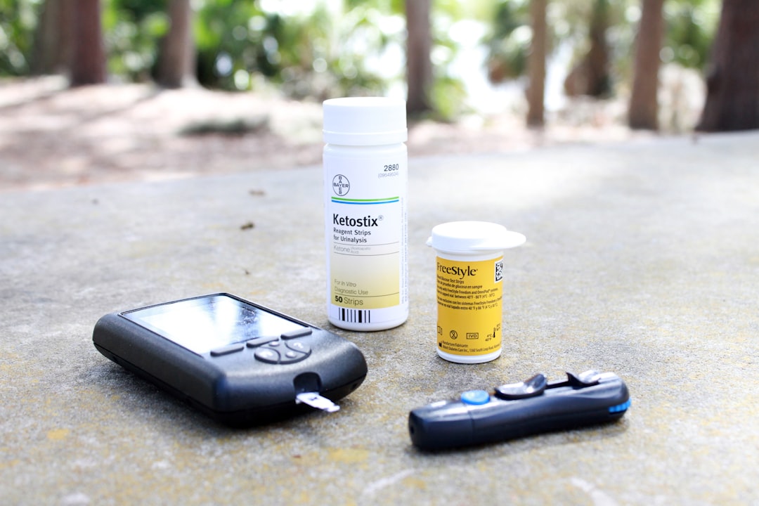 black smartphone beside white plastic bottle and black smartphone,