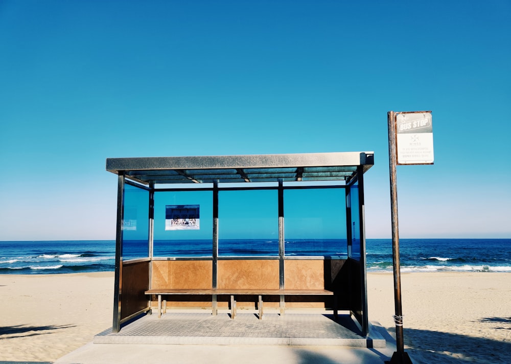 brown wooden bench on beach during daytime