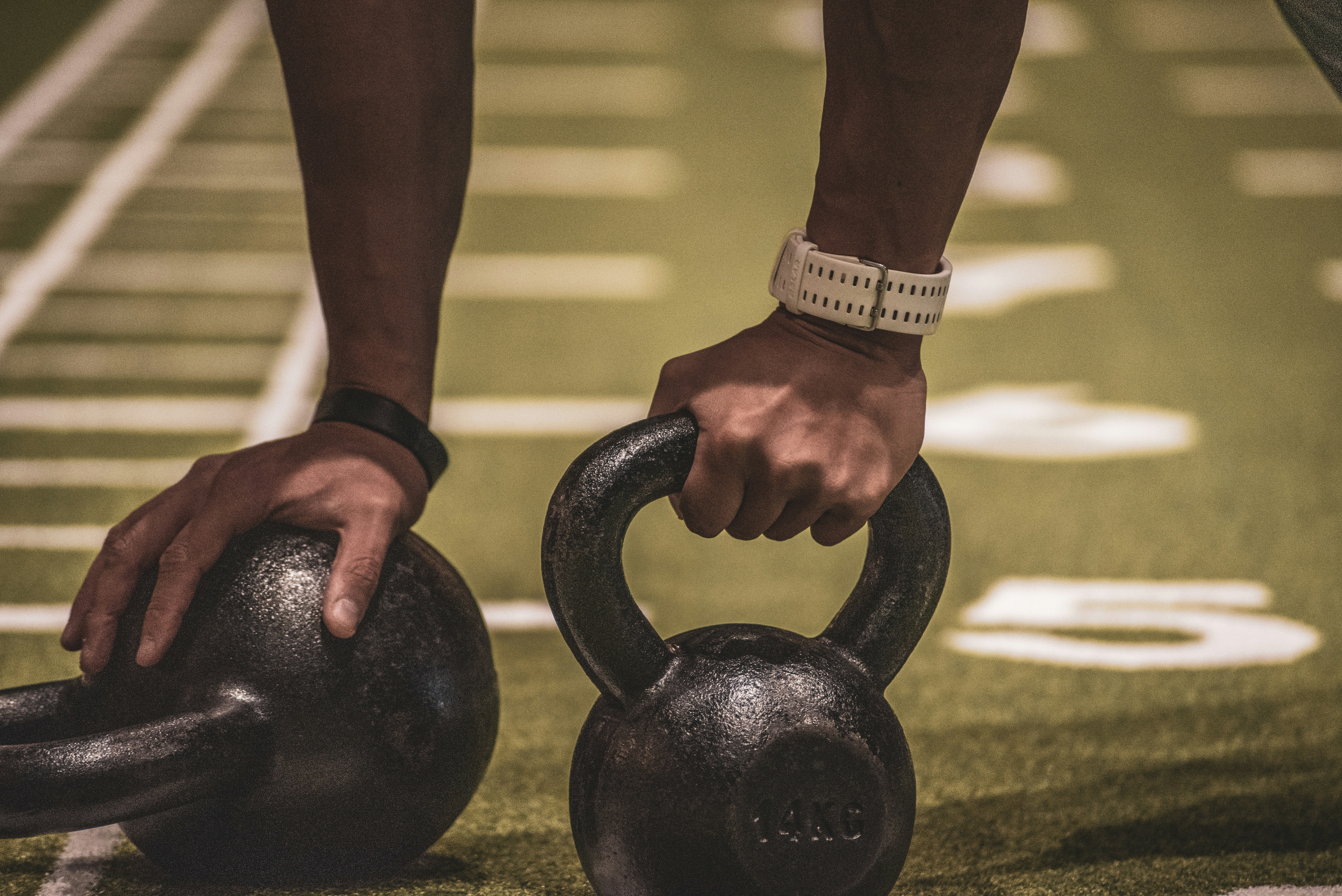 person holding black kettle bell