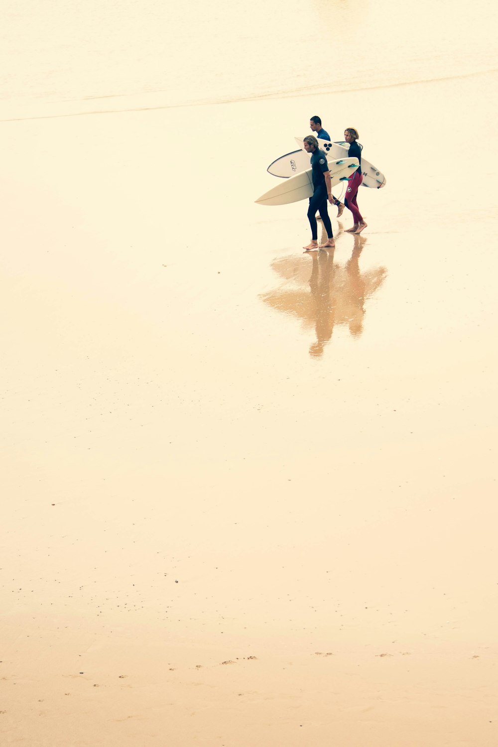 person in blue and white shirt walking on white sand during daytime