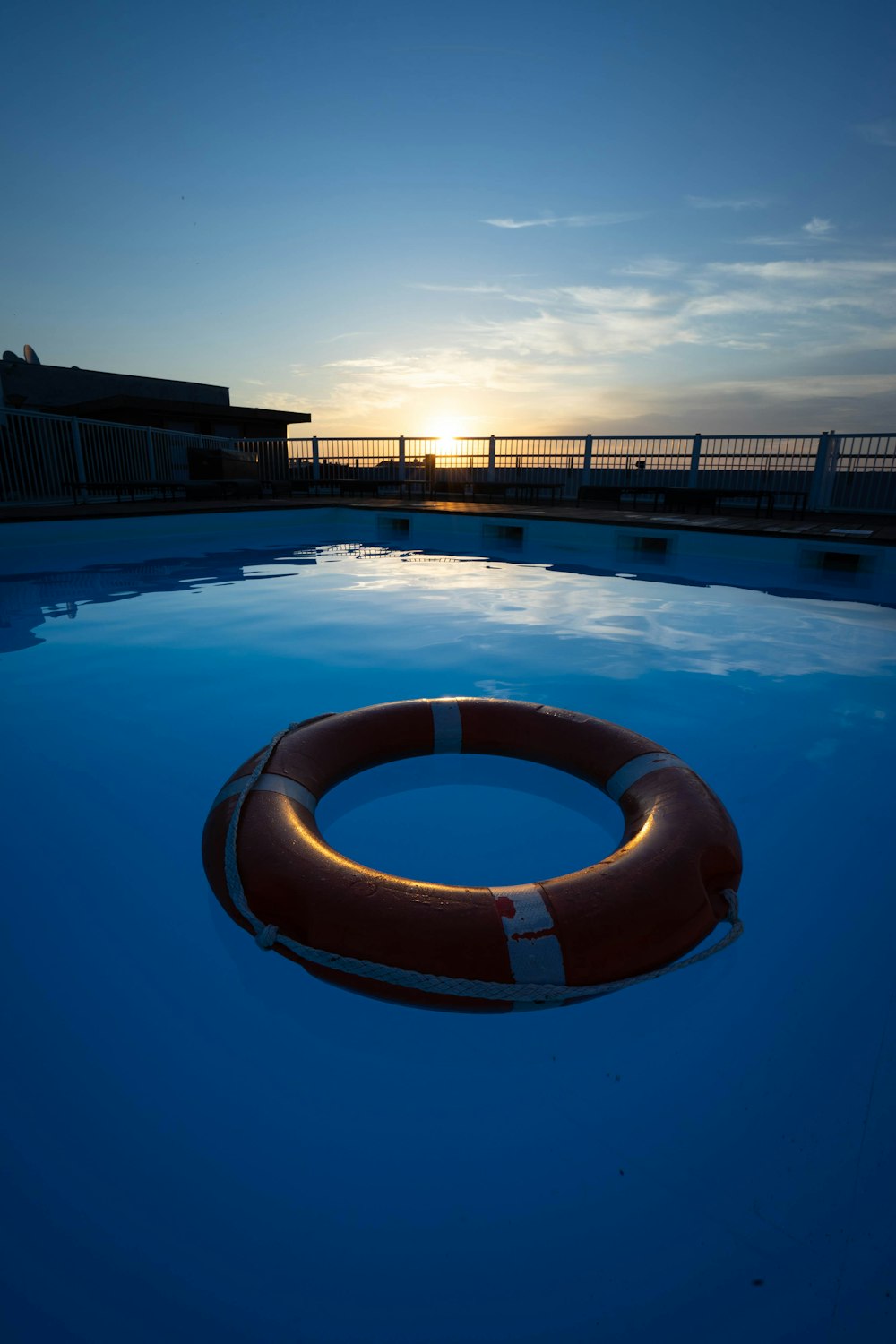 blue swimming pool near brown building during daytime