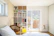 Bright, modern bedroom setup in a small guesthouse with stylish furniture.