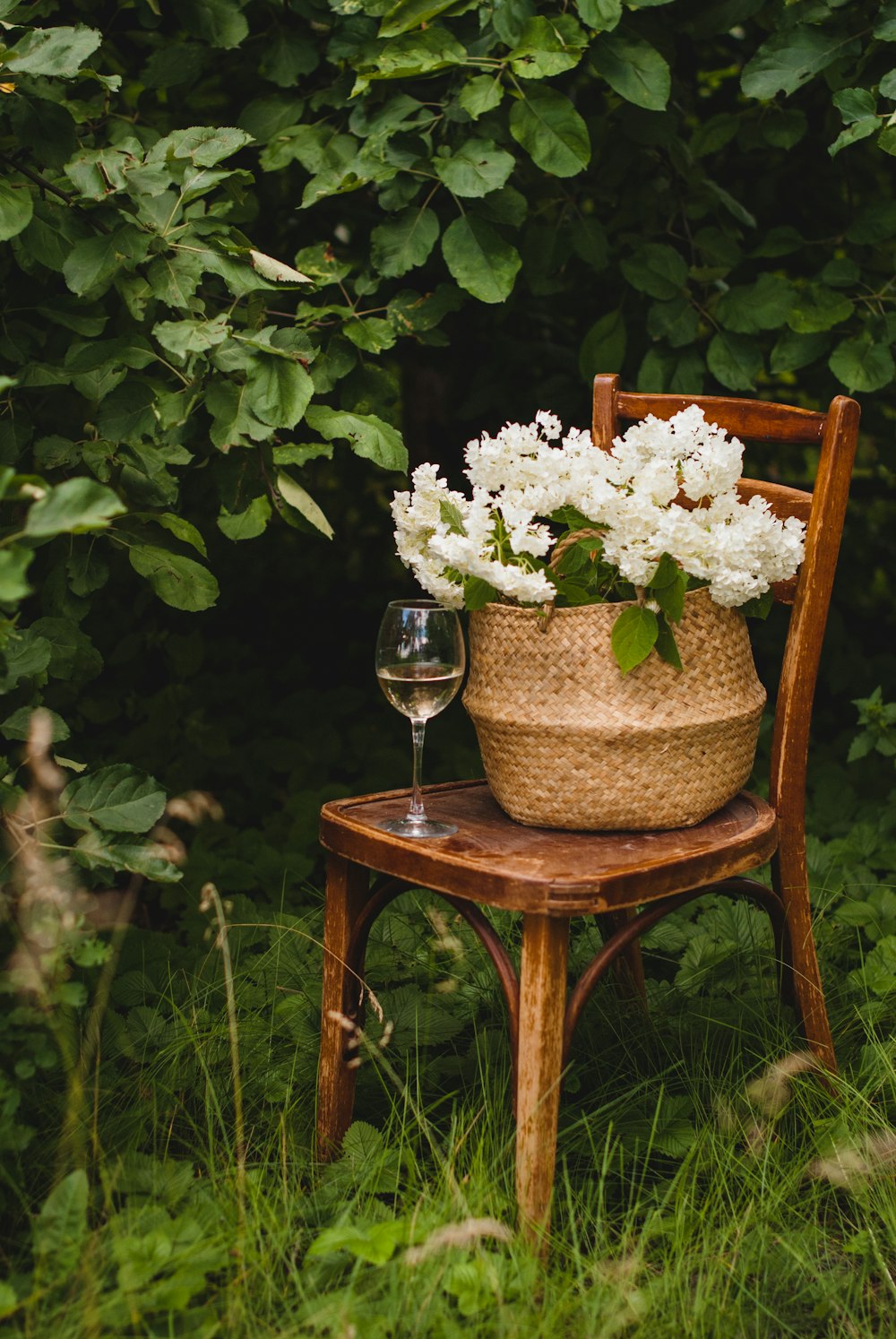 white flowers in clear glass vase on brown wooden table