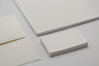 Corporate stationery set including business cards, letterheads, and envelopes.