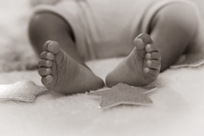 grayscale photo of babys feet