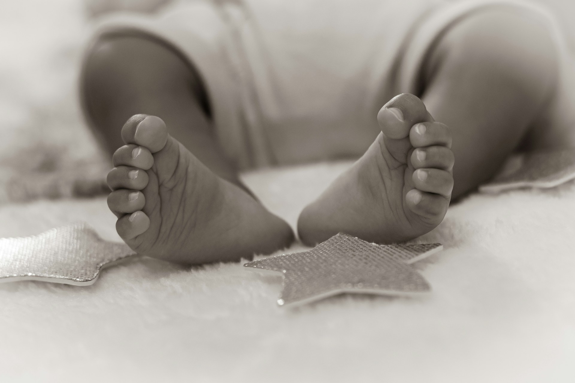 grayscale photo of babys feet