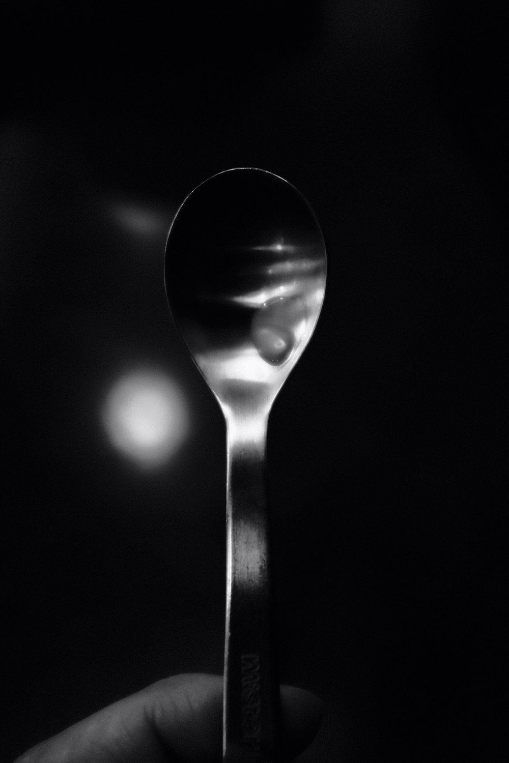 silver spoon on black surface