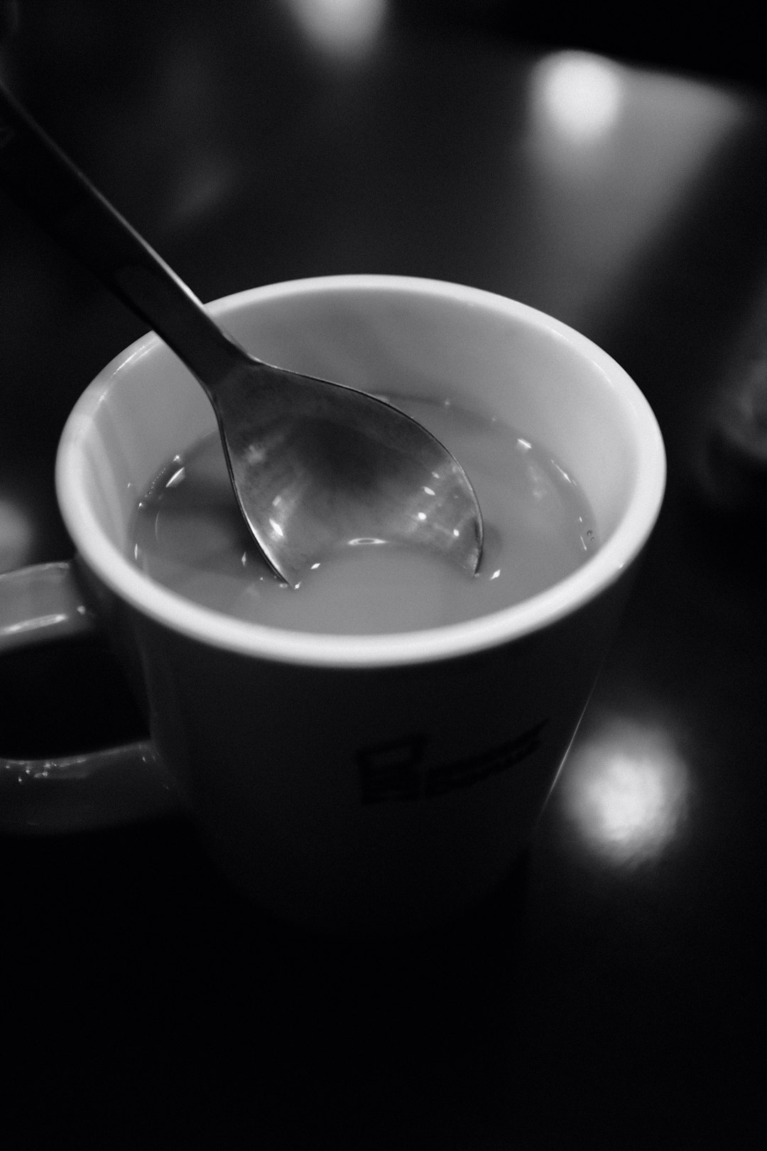 stainless steel spoon in white ceramic mug