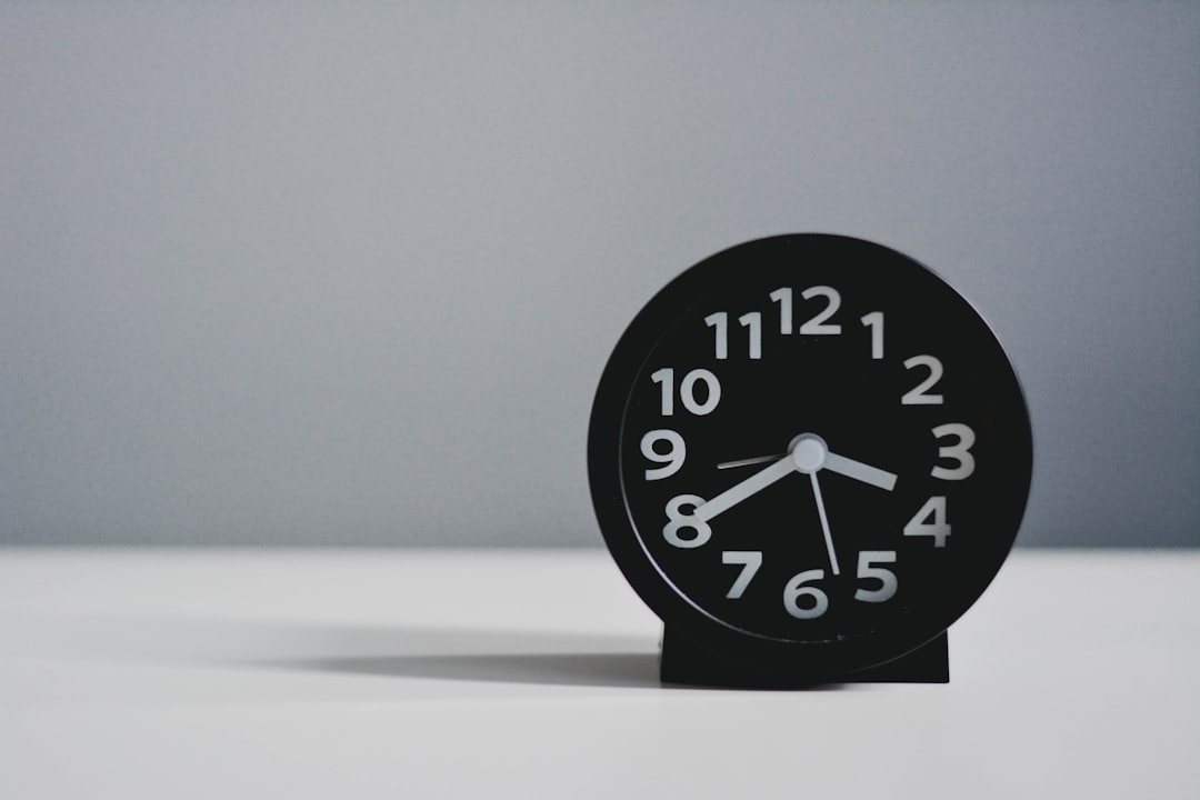 black round analog clock at 10 00