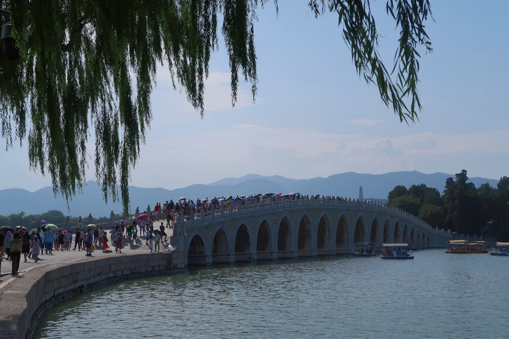 people walking on gray concrete bridge during daytime