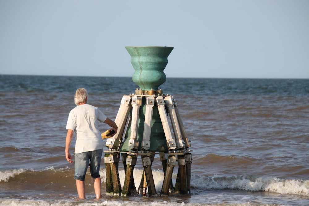 man and woman standing on beach during daytime