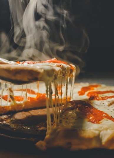 close up photo of pizza with cheese